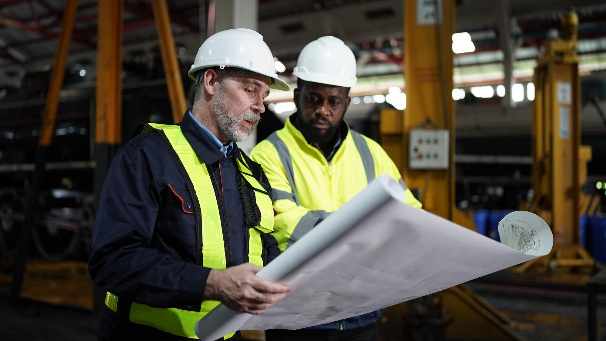 Engineers reading blueprints